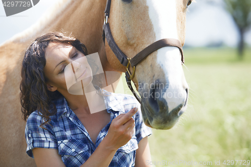 Image of Woman and horse together at paddock