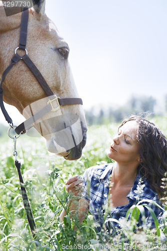 Image of Woman and horse together at paddock