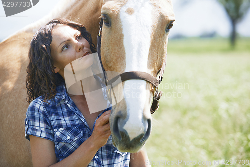 Image of Woman and horse together at paddock