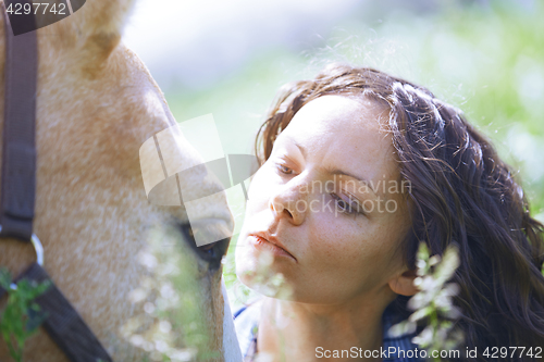 Image of Woman and horse together at paddock