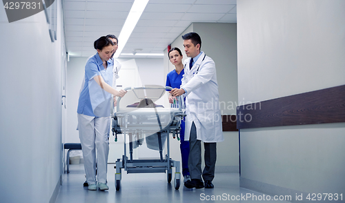 Image of medics and patient on hospital gurney at emergency