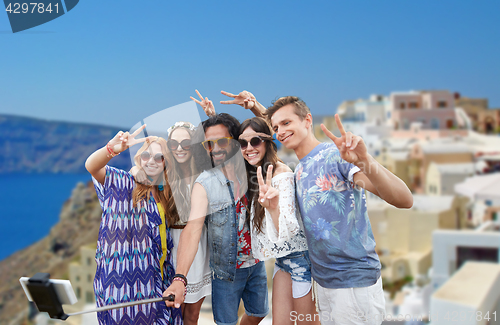 Image of hippie friends with smartphone on selfie stick