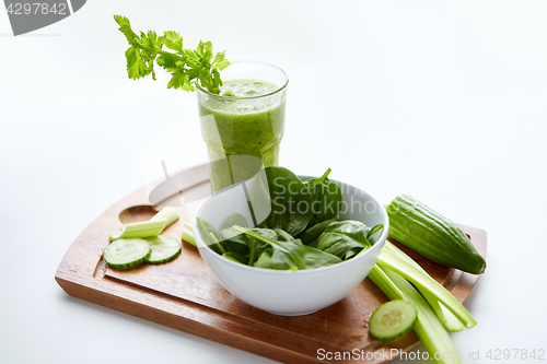 Image of close up of glass with green juice and vegetables