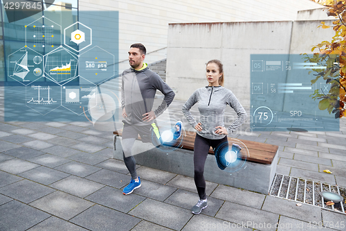 Image of couple doing lunge exercise on city street