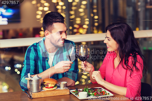 Image of happy couple dining and drink wine at restaurant