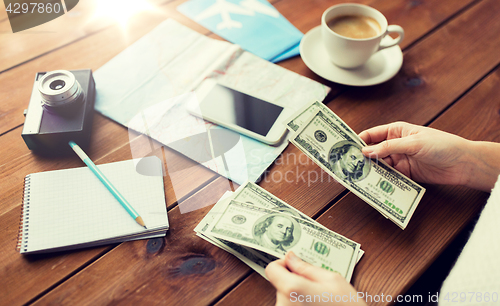 Image of close up of traveler hands counting dollar money