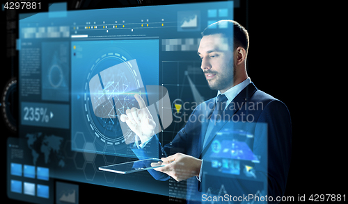 Image of businessman with tablet pc and virtual screen