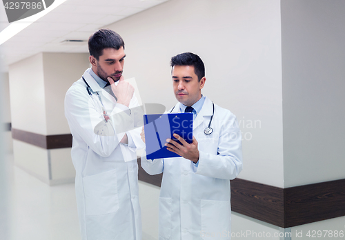 Image of two male doctors with clipboard at hospital