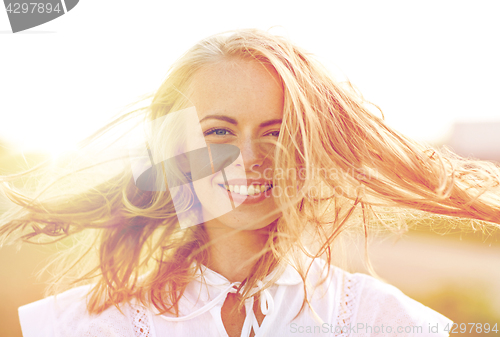 Image of close up of happy young woman in white outdoors