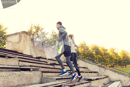 Image of couple running upstairs on stadium