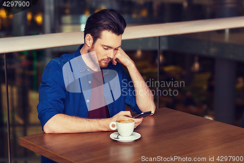 Image of man with smartphone and coffee at restaurant