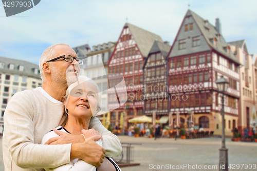 Image of senior couple hugging over frankfurt background