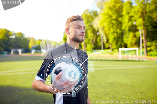 Image of soccer player with ball on football field