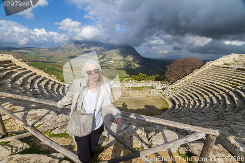 Image of Tourist taking photo in front of greek theater of Segesta, Sicily, Italy