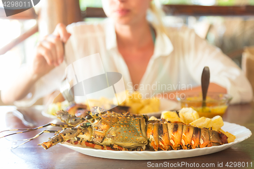 Image of Grilled lobster served with potatoes and coconut sauce.