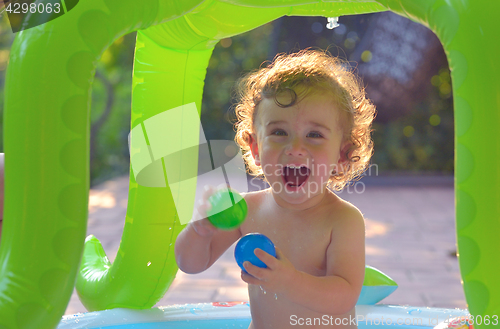 Image of Laughing little girl play in the pool 