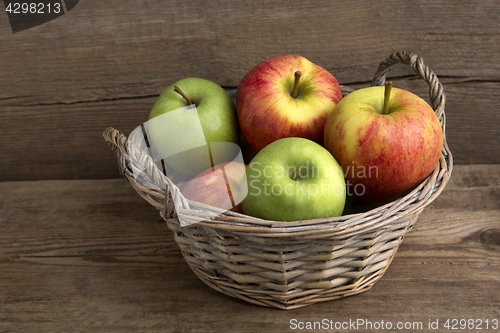 Image of Basket of fresh apples on wooden background