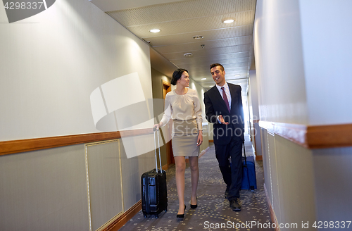 Image of business team with travel bags at hotel corridor