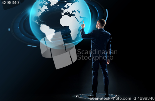 Image of businessman in suit touching earth globe hologram