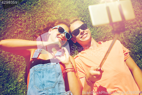 Image of happy couple taking selfie on smartphone at summer