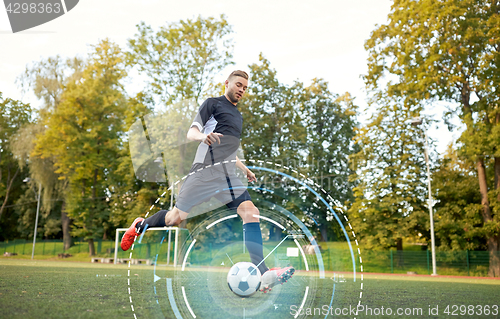 Image of soccer player playing with ball on football field