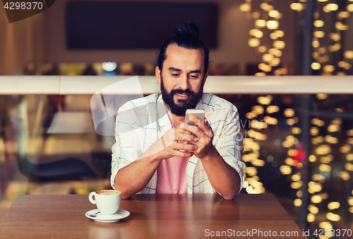 Image of happy man with smartphone and coffee at restaurant