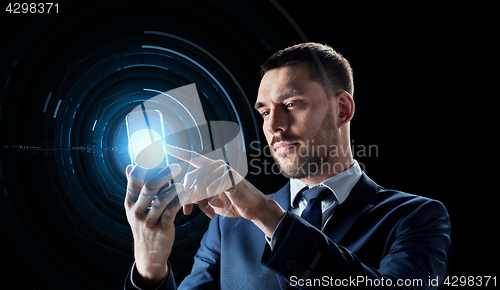 Image of businessman with transparent smartphone