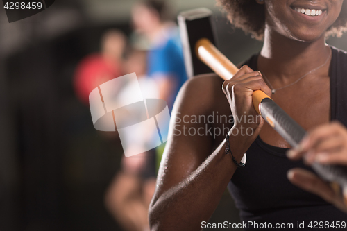 Image of black woman after workout with hammer