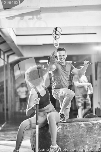 Image of multiethnic couple after workout with hammer