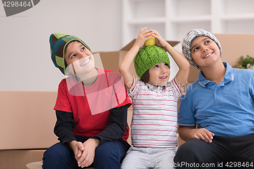 Image of boys with cardboard boxes around them