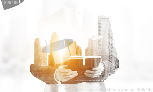 Image of Double exposure of senior businessman with tablet