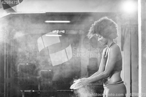 Image of black woman preparing for climbing workout