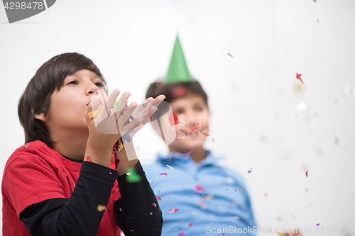 Image of kids  blowing confetti