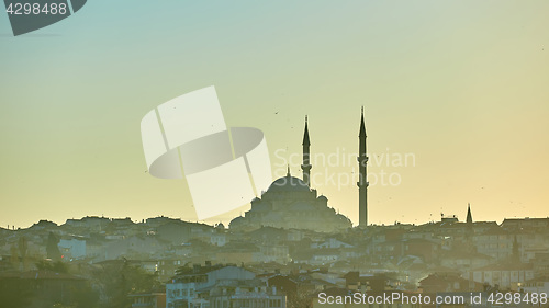 Image of Silhouette of a Mosque Fatih in a fog and sunlight reflections. Vintage style.