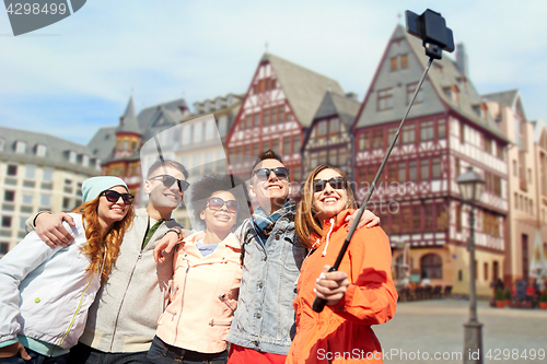 Image of friends taking photo by selfie stick in frankfurt