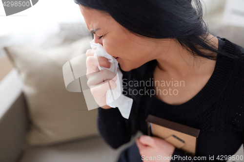 Image of crying woman with photo frame at funeral day