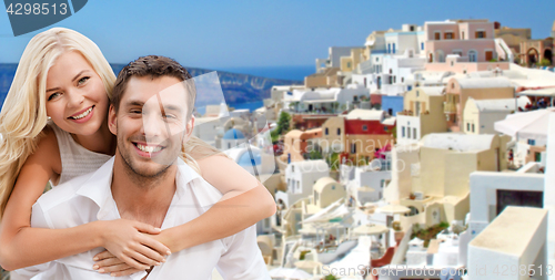 Image of happy couple hugging over santorini island
