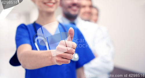 Image of close up of doctors at hospital showing thumbs