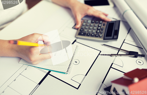 Image of close up of architect hand counting on calculator