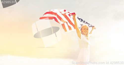 Image of happy woman with american flag outdoors