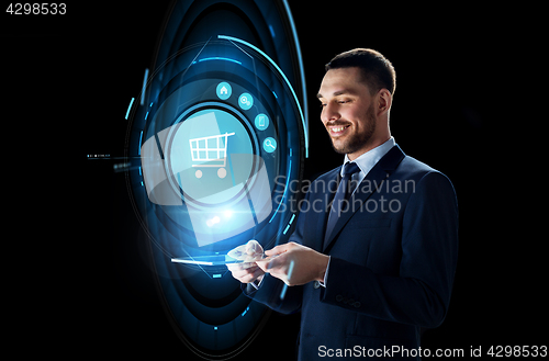 Image of businessman with tablet pc and shopping cart icon