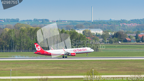 Image of Passenger plane of Air Berlin airline touching down with smoke