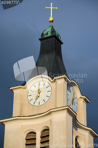 Image of Bell tower with antique clock and golden cross