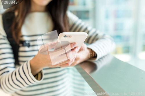 Image of Woman checking something on cellphone