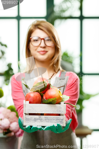 Image of Happy model. Focused on apples