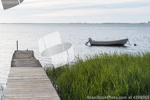 Image of Old jetty and an anchored small boat