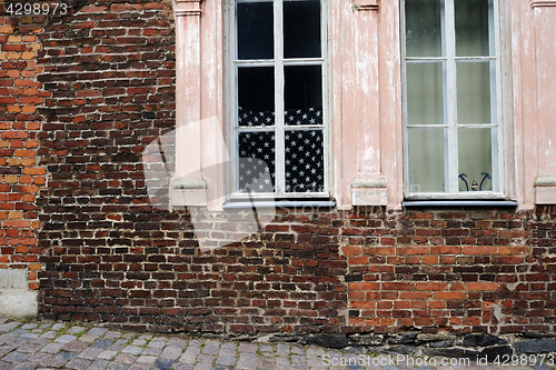 Image of brick wall and american flag in the window