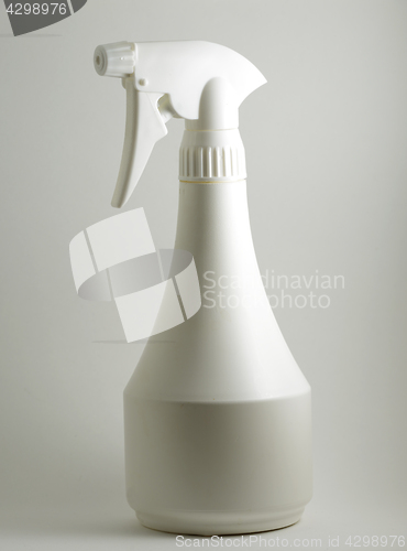 Image of white plastic sprayer on a neutral