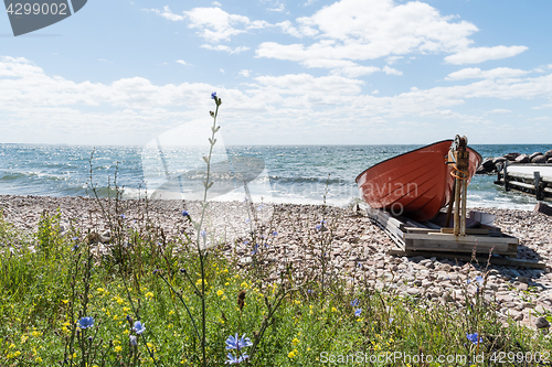 Image of Landed red rowing boat