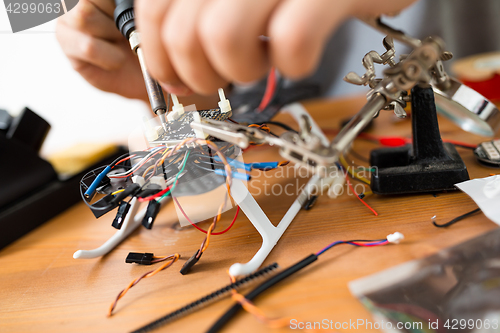 Image of Man installing the accessories on drone body